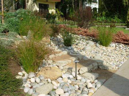  river rock entry garden is installed above an in ground infiltration