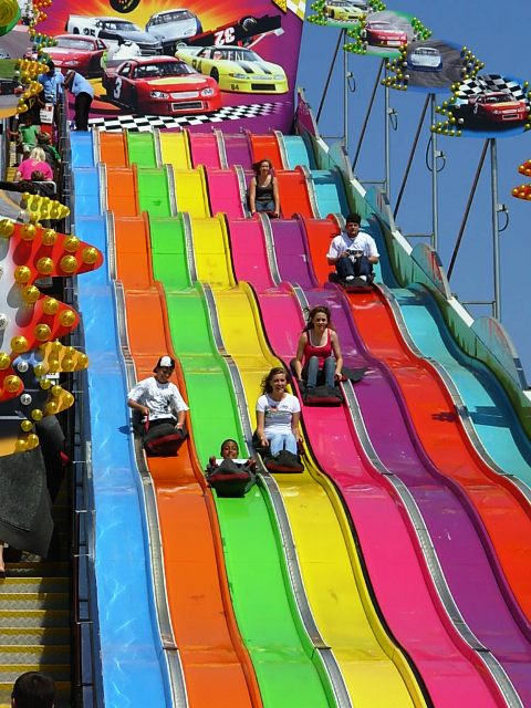burlap sack slide in rainbow colors with multiple people